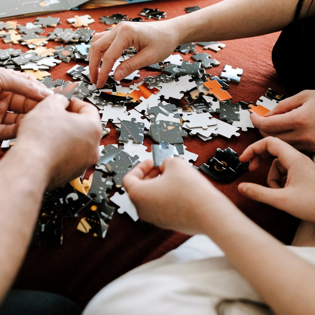 Family completing custom puzzle for speed puzzling practice - The Missing Piece Puzzle Company