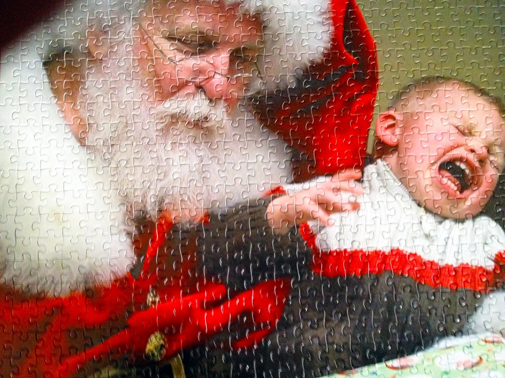 custom puzzle of santa holding crying child.  Photo puzzle has been cut into 500 piece photo puzzle.