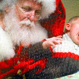 custom puzzle of santa holding crying child.  Photo puzzle has been cut into 500 piece photo puzzle.