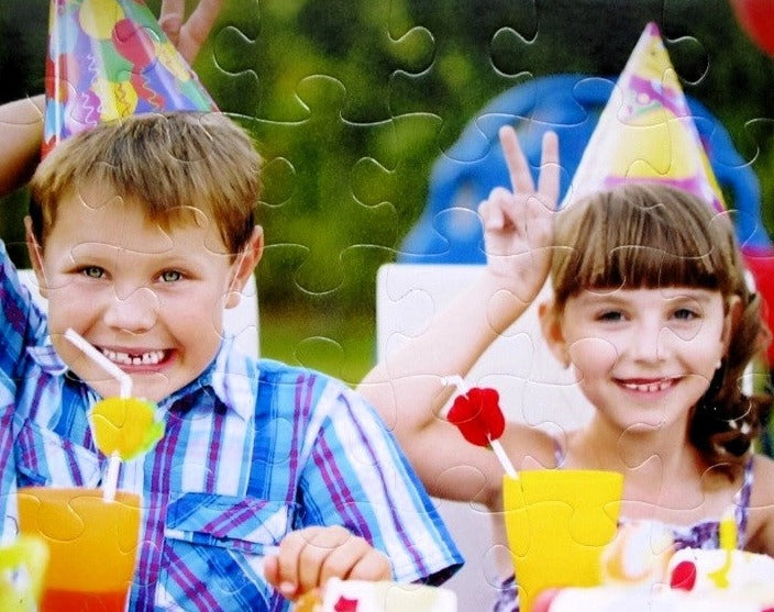 personalized puzzle for birthday gift cheap.  Puzzle shows 2 kids with birthday party hats smiling.  Bright colors in photo