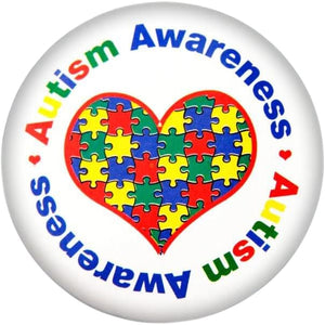 autism awareness pin with a heart and colorful puzzle pieces