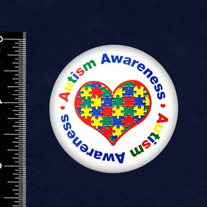 autism awareness pin next to a ruler showing that it is approximately 2 inches in diameter