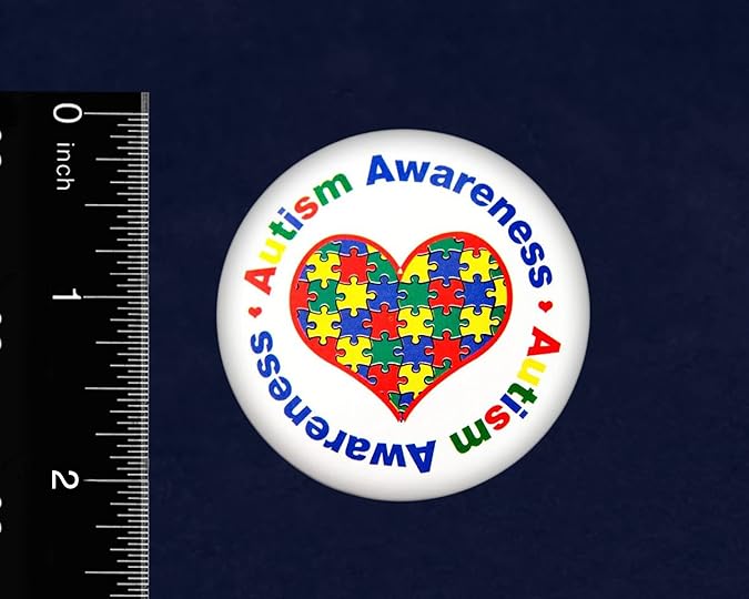 autism awareness pin next to a ruler showing that it is approximately 2 inches in diameter
