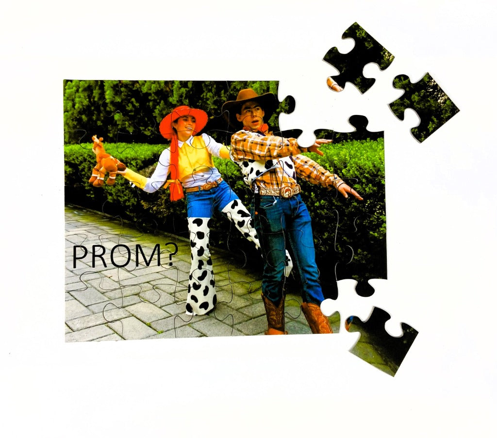 Design your own promposal puzzle from your picture.  Unique Ask to Prom with puzzle.  Couple dressed in pixars sheriff woody and jesse outfits with PROM written on the cut puzzle.