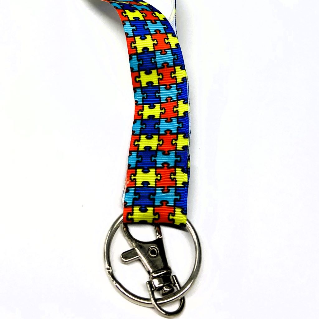 lanyard with puzzle pieces in bright colors.  Layard for autism awareness